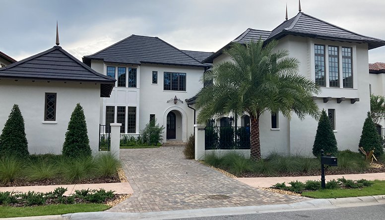 Large white two-story house with dark roof