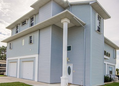 Tall light-blue house with vertical siding
