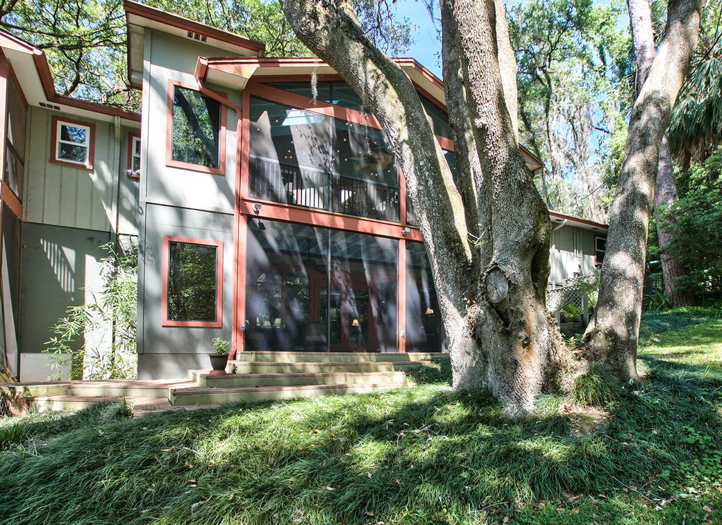 Traditional home with a large tree in the yard