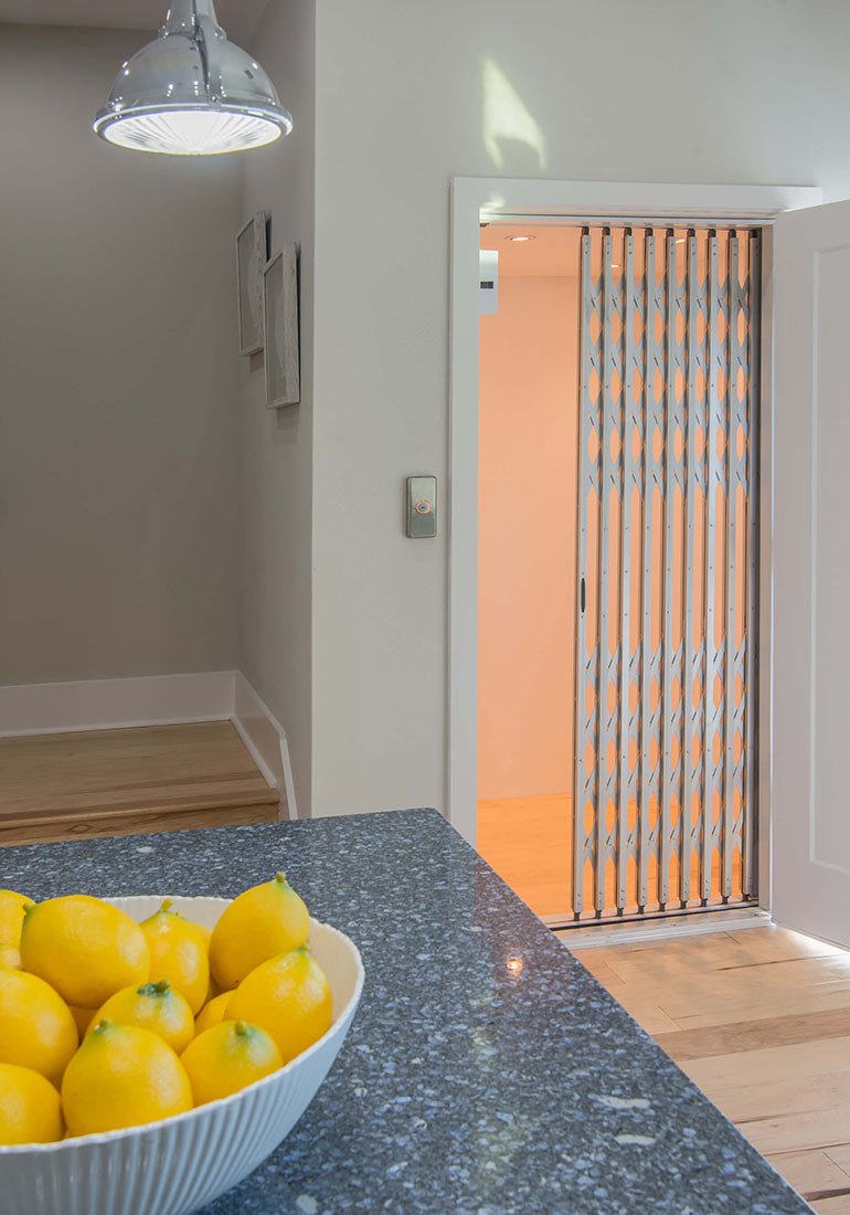 Elevator next to kitchen island