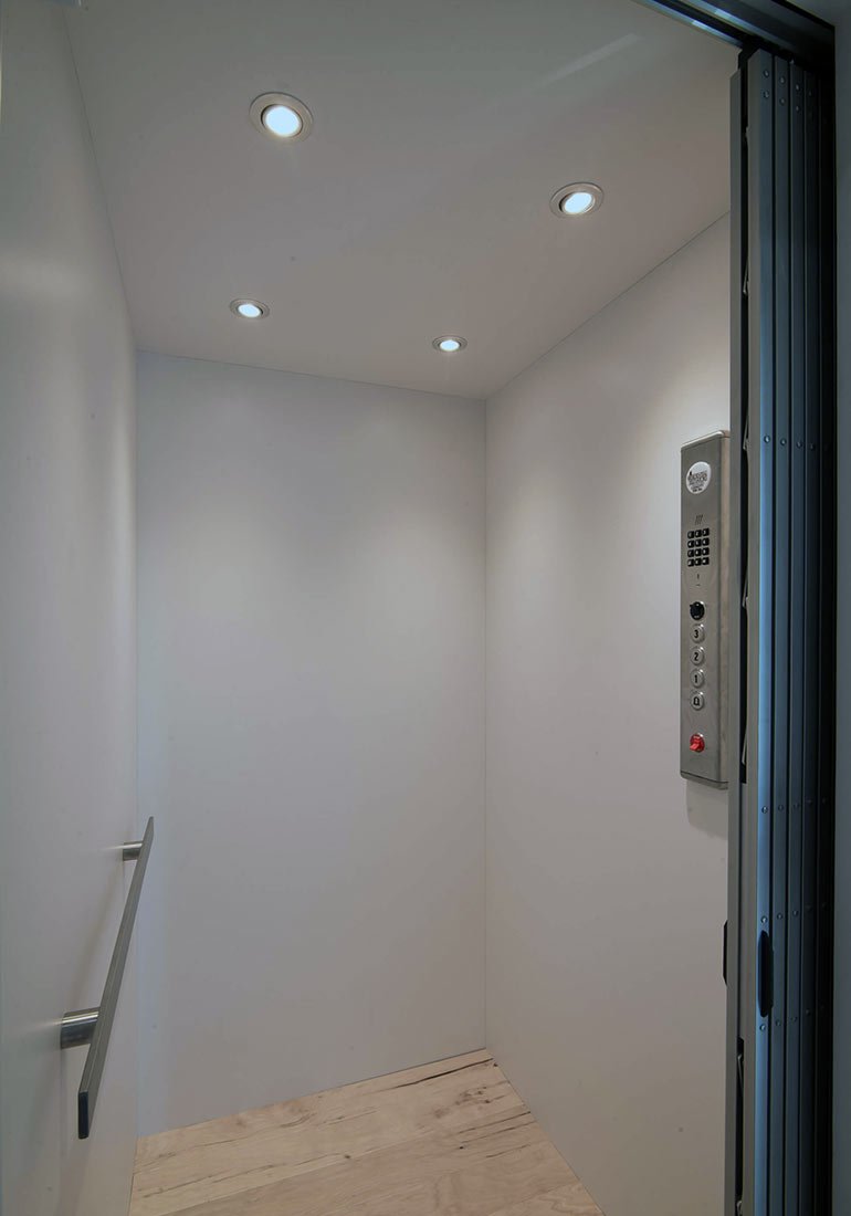 Home elevator with open gate and control panel