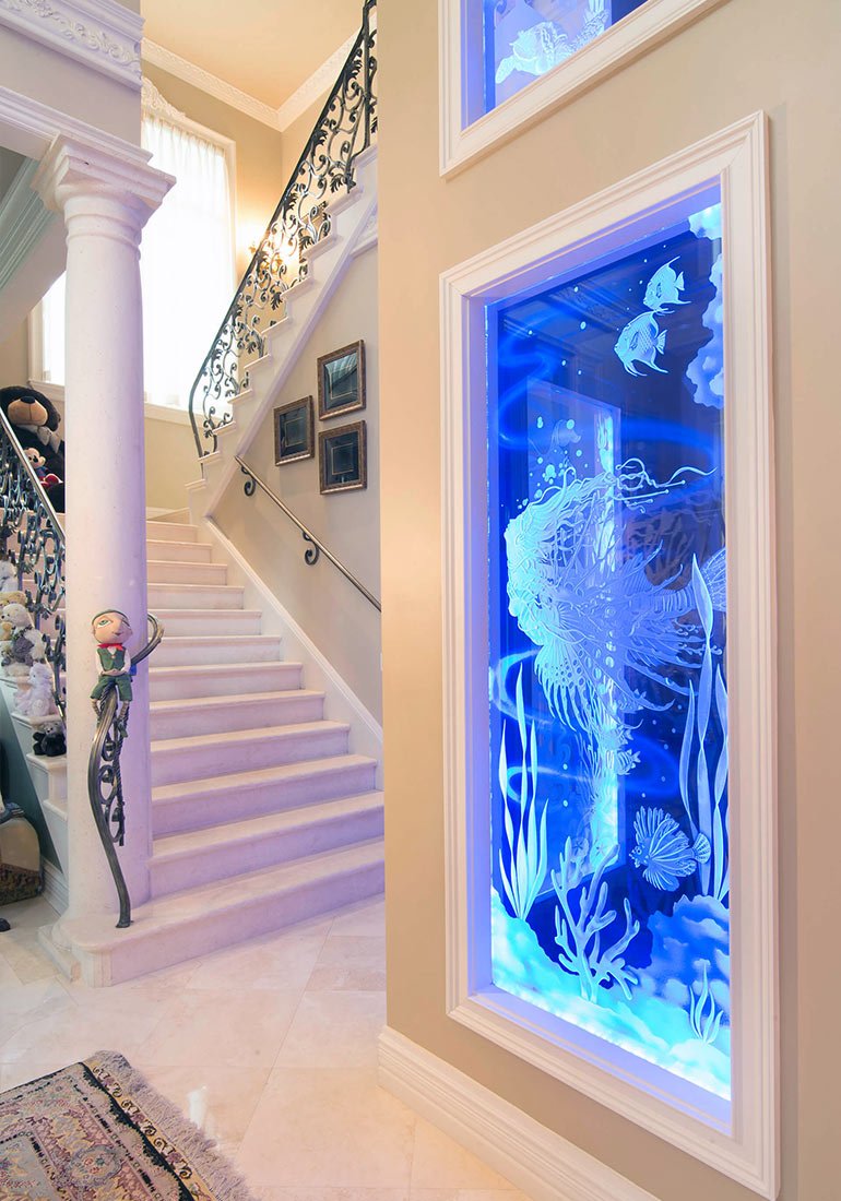 Home elevator shaft with glowing ocean-themed glass panel