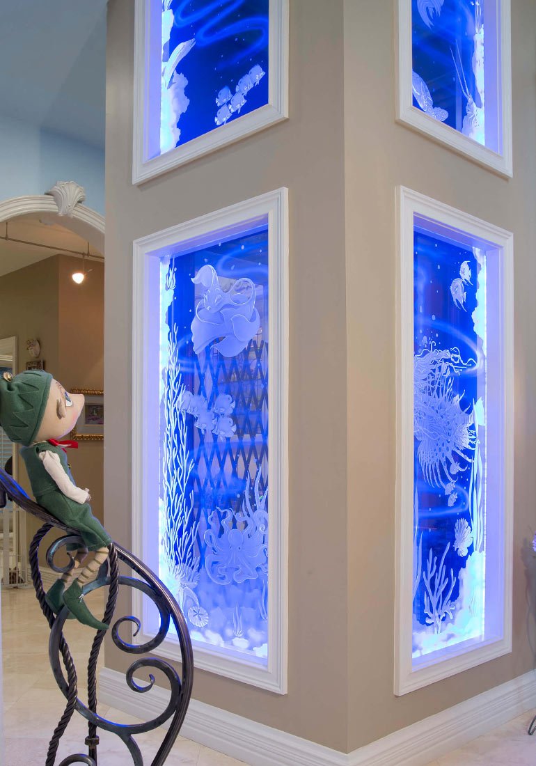 Home elevator shaft with glowing ocean-themed glass panel