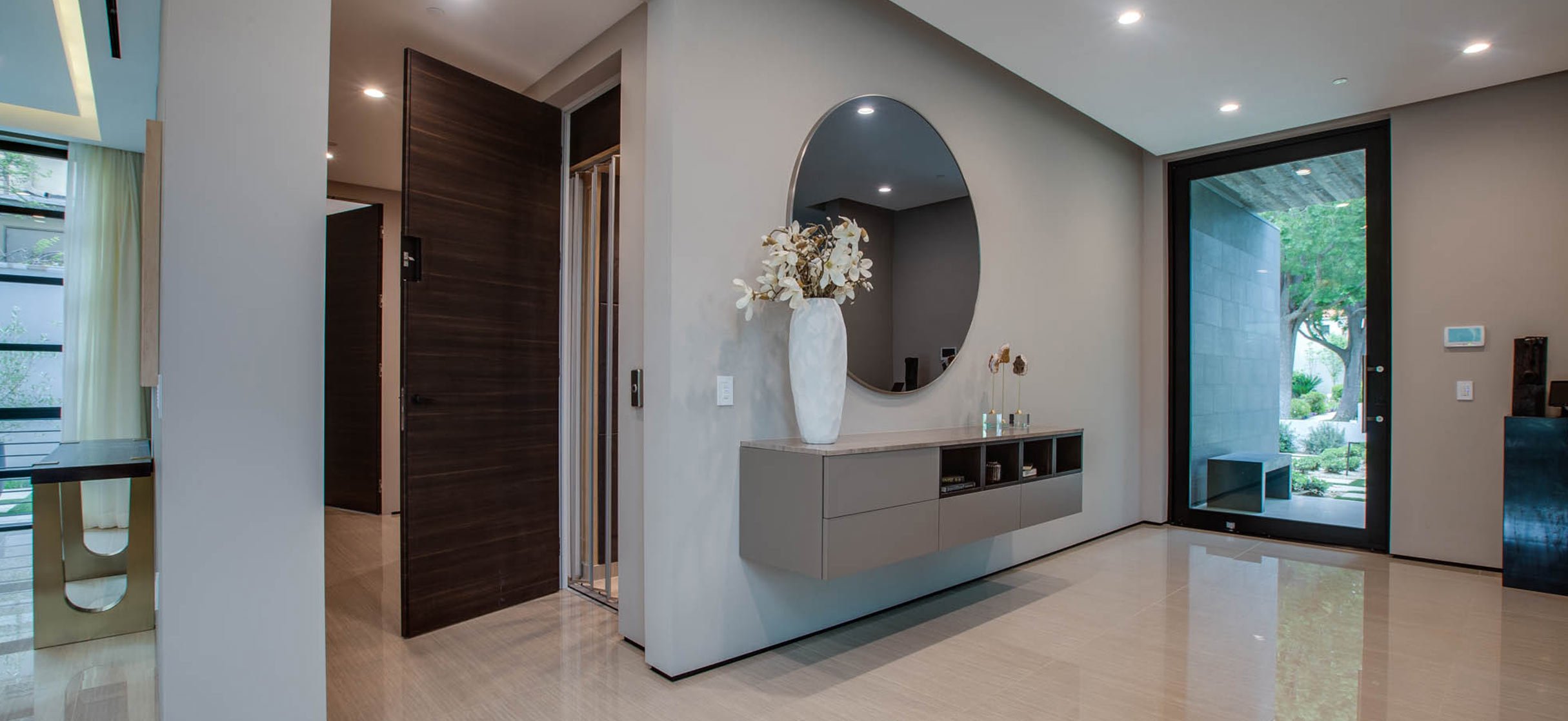 Modern entryway with an open home elevator door