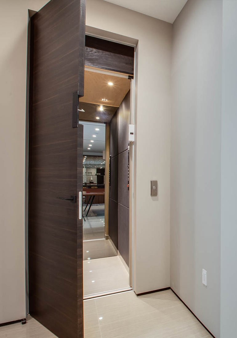 Modern hallway with an open home elevator door