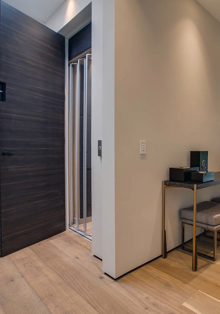 Modern entryway with an open home elevator door