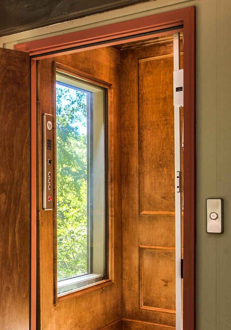 Home elevator with wood paneling