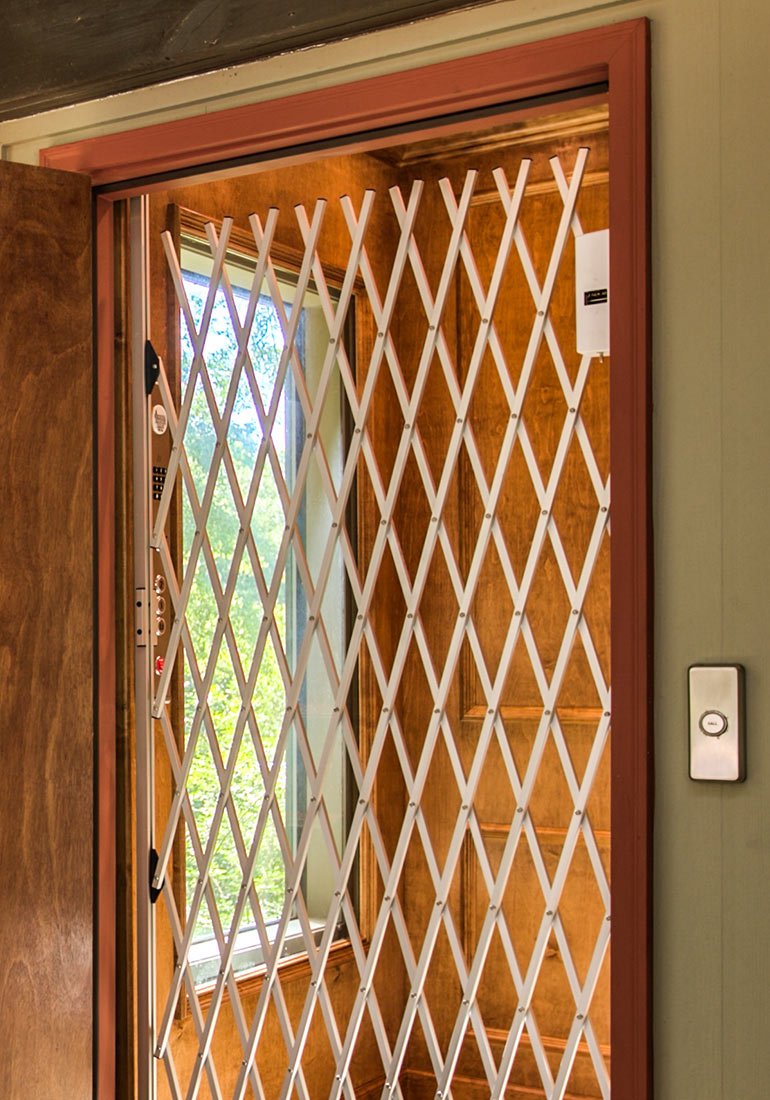 Home elevator with wood paneling and gate