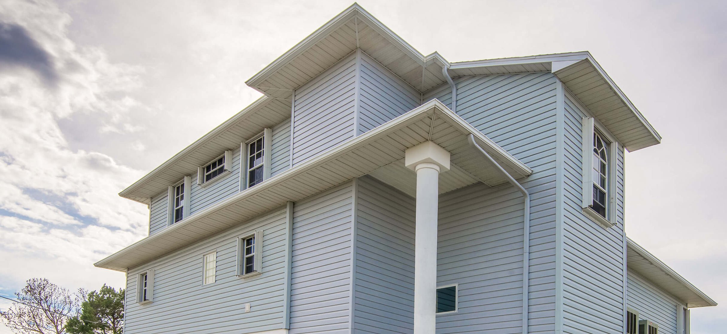 Tall light-blue house with vertical siding