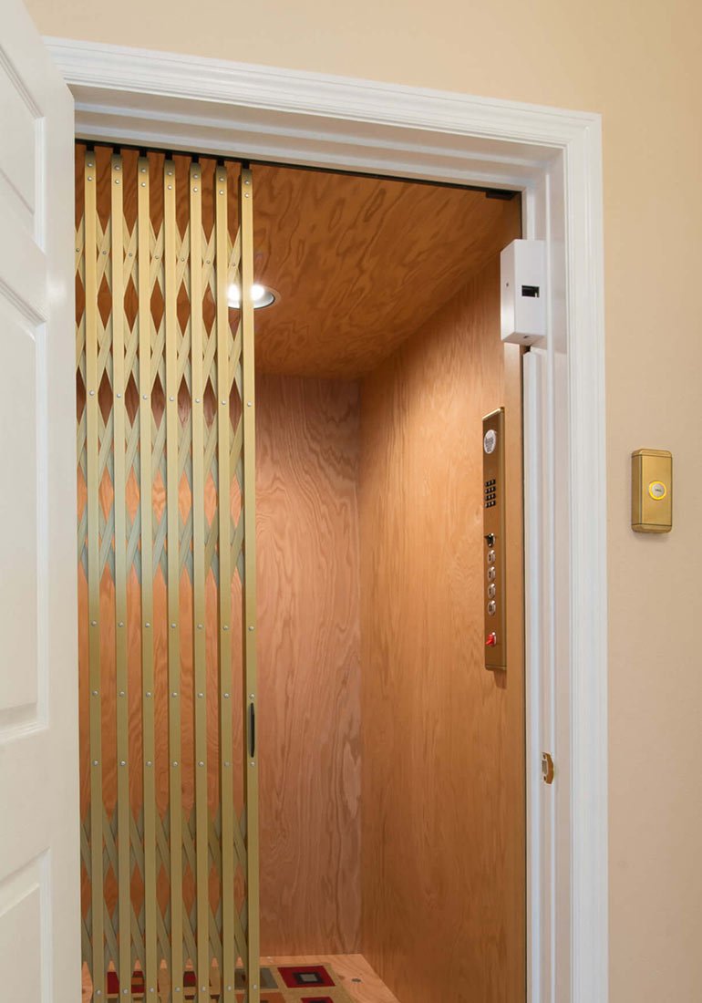 Home elevator with gold accordion gate