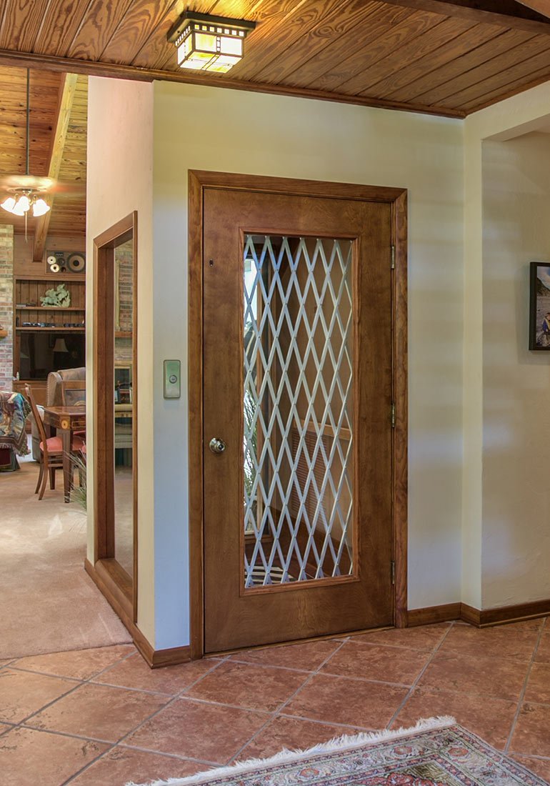 Home elevator with a wooden door
