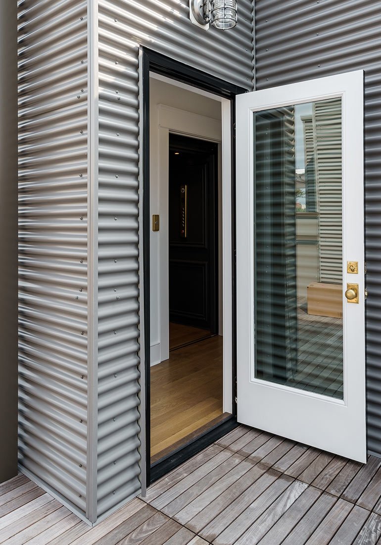 Exterior door opens to a home elevator entrance